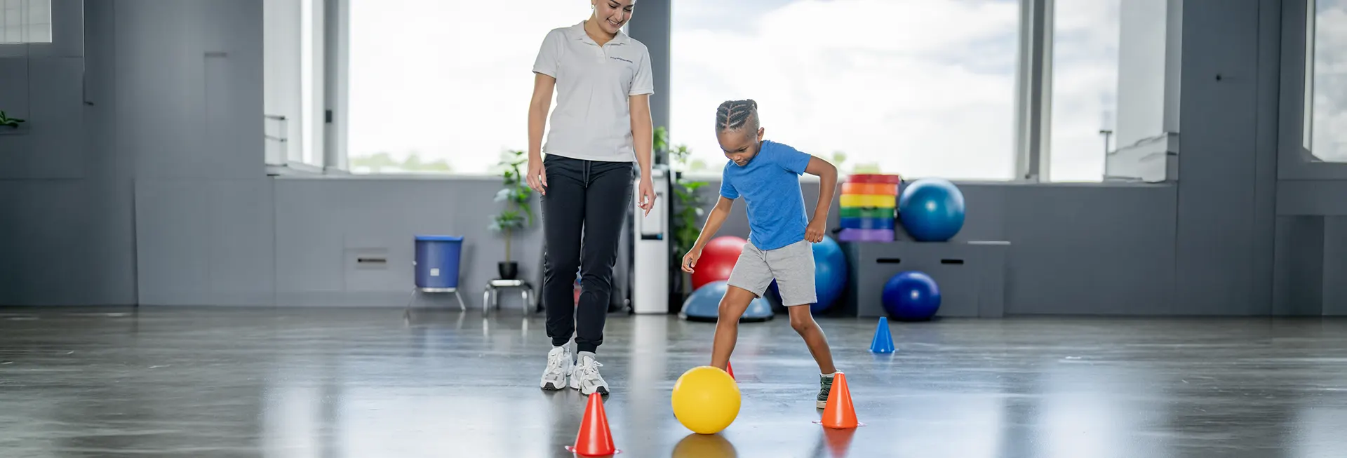 physiotherapist exercising with young boy